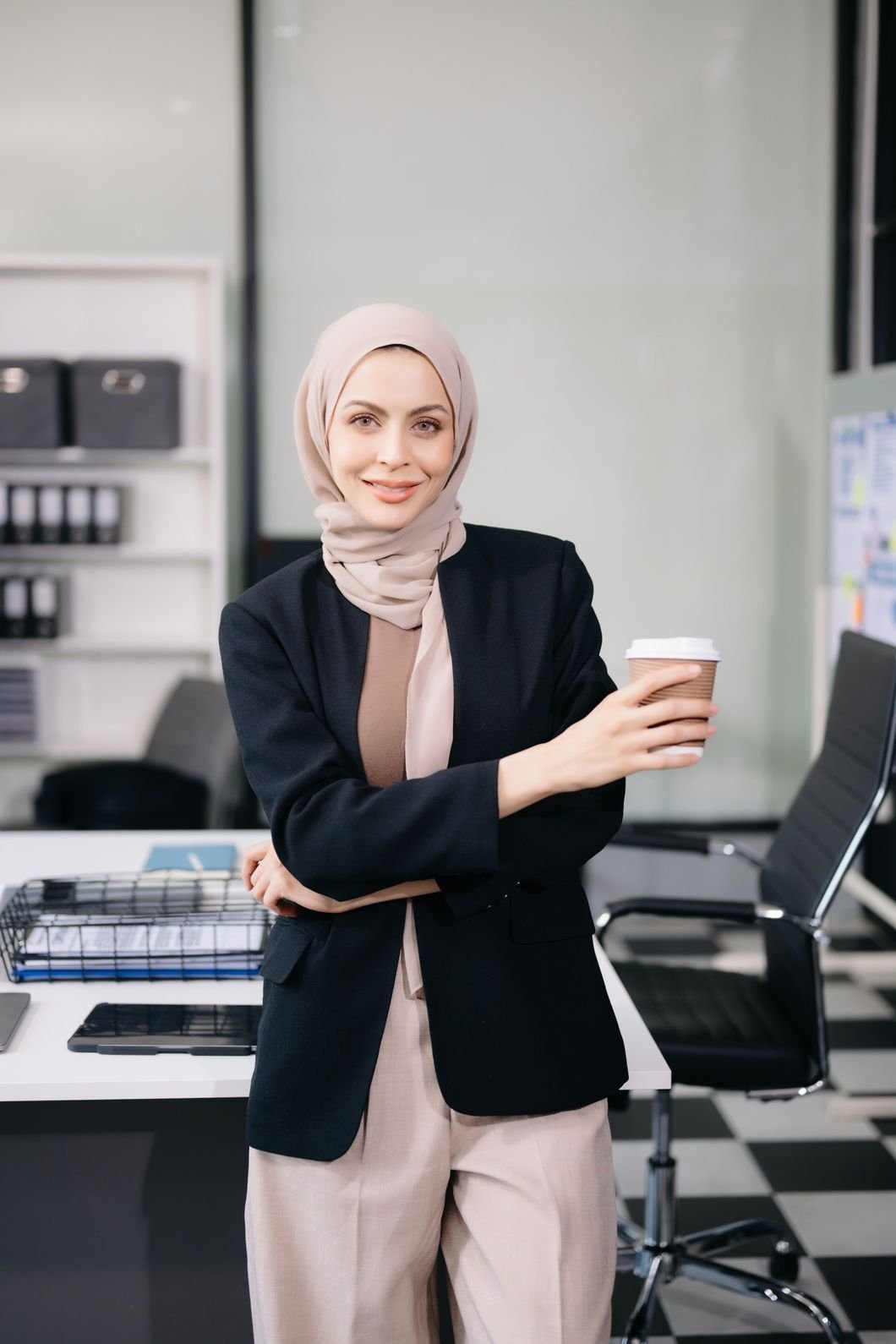 Female Entrepreneur Looking At The Camera While St FQVY956